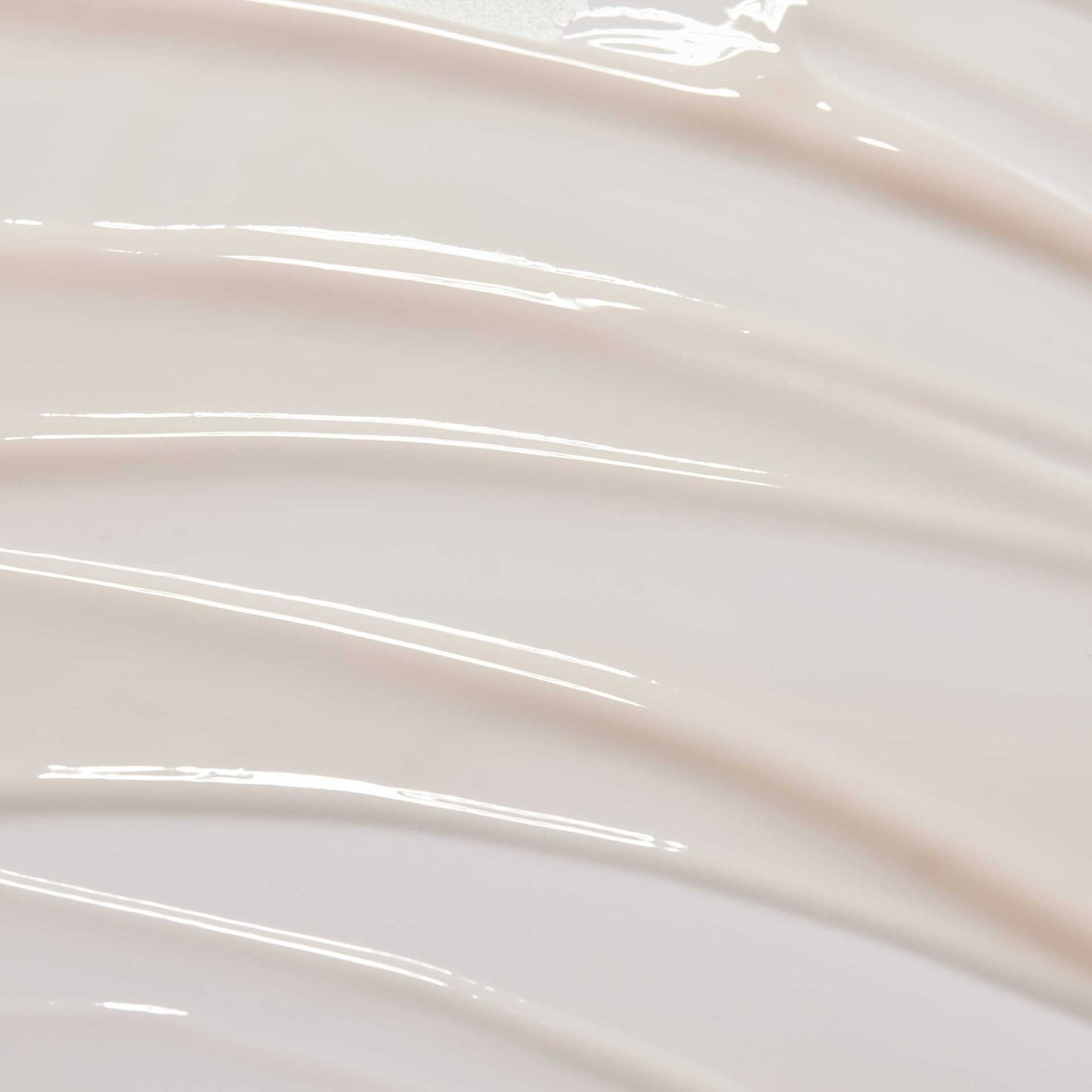 huecalm-Serum texture close-up – lightweight milky formula on swirled background