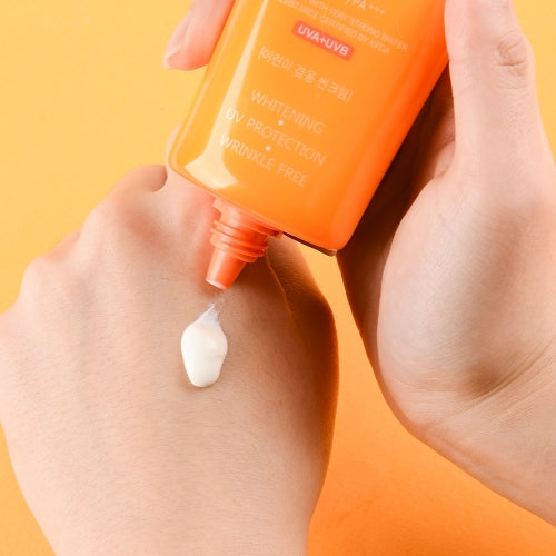 Jigott Snail UV Sunscreen being applied to back of hand showing white cream texture