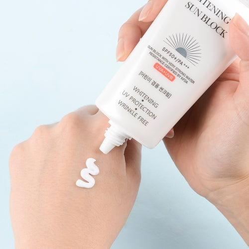 Jigott Whitening UV Sunscreen being applied to hand showing white cream texture